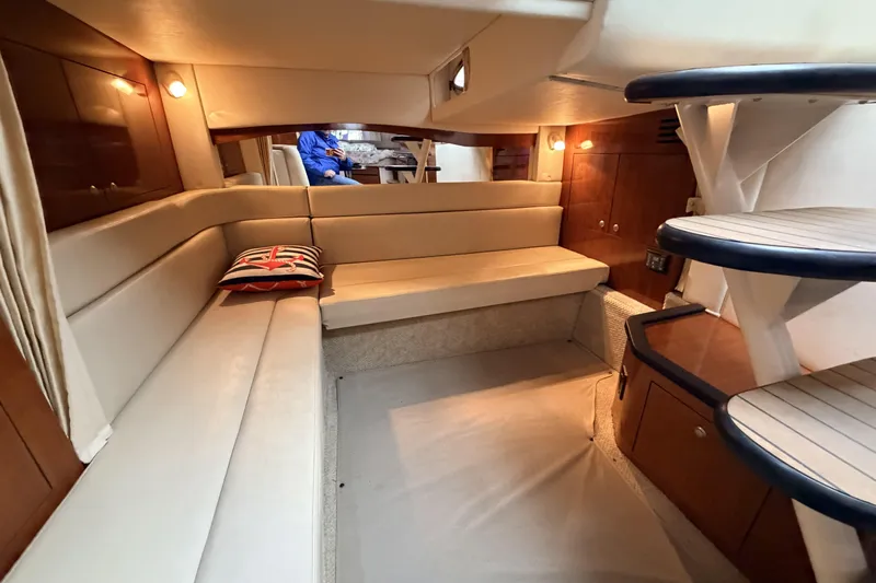  Yacht Photos Pics Interior of 2006 Sea Ray 340 Sundancer with beige seating and wooden accents.
