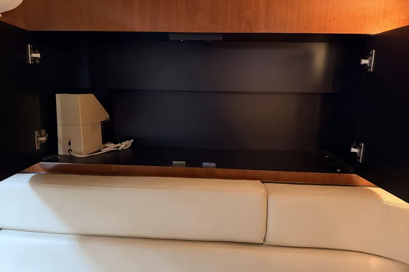  Yacht Photos Pics 2006 Sea Ray 340 Sundancer interior cabinet with beige seating and electronic device.