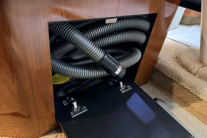  Yacht Photos Pics Storage compartment with coiled hoses in a 2006 Sea Ray 340 Sundancer boat interior.