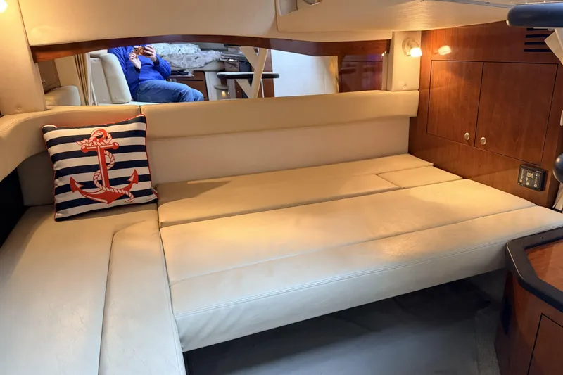  Yacht Photos Pics Interior of 2006 Sea Ray 340 Sundancer with beige seating and nautical-themed pillow.