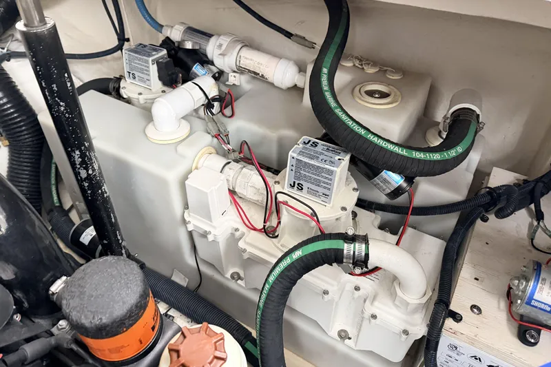  Yacht Photos Pics Engine compartment of a 2006 Sea Ray 340 Sundancer with visible hoses and components.