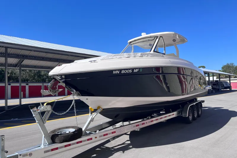  Yacht Photos Pics 2019 Regal 33 SAV boat on trailer under clear blue sky.