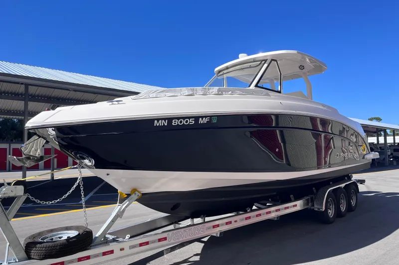  Yacht Photos Pics 2019 Regal 33 SAV boat on trailer under clear blue sky.