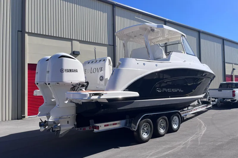  Yacht Photos Pics 2019 Regal 33 SAV boat on trailer with Yamaha engines, parked outside.