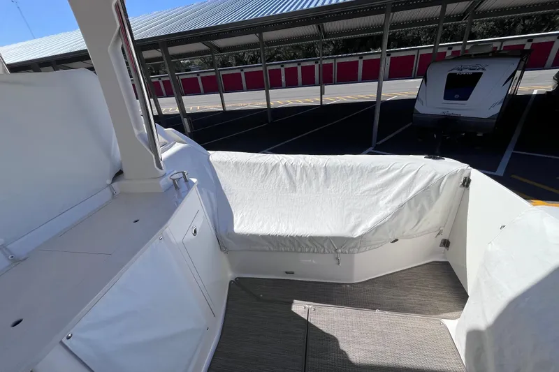  Yacht Photos Pics 2019 Regal 33 SAV boat interior with covered seating in a parking area.