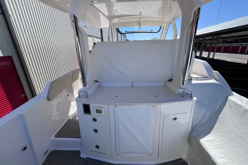 Yacht Photos Pics 2019 Regal 33 SAV boat interior with covered seating and storage compartments.