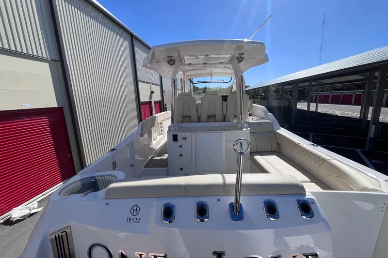  Yacht Photos Pics 2019 Regal 33 SAV boat with spacious seating and sleek design in a storage facility.