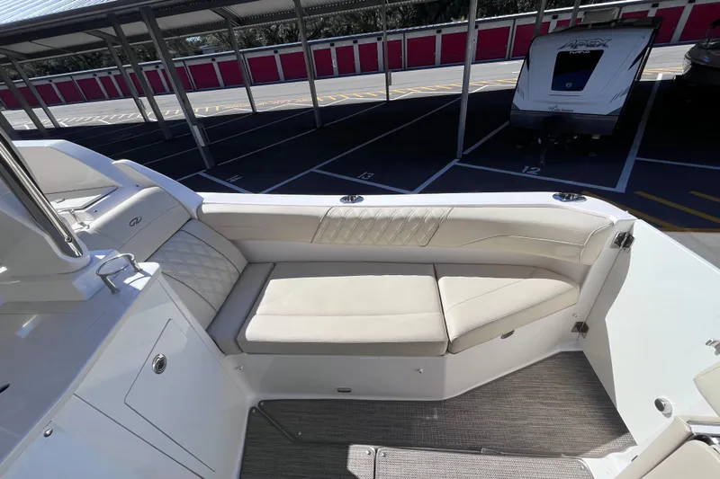  Yacht Photos Pics 2019 Regal 33 SAV boat interior with beige seating in a covered parking area.