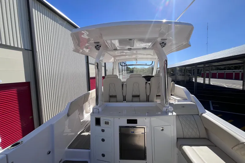  Yacht Photos Pics 2019 Regal 33 SAV boat interior with seating and storage, docked under clear blue sky.