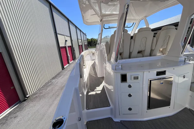  Yacht Photos Pics 2019 Regal 33 SAV boat interior with seating and storage, docked near storage units.