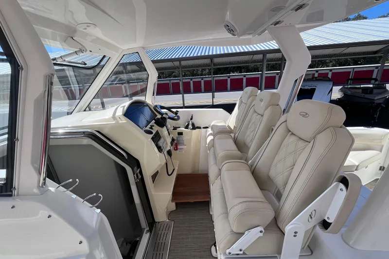  Yacht Photos Pics 2019 Regal 33 SAV boat interior with luxurious seating and modern dashboard.