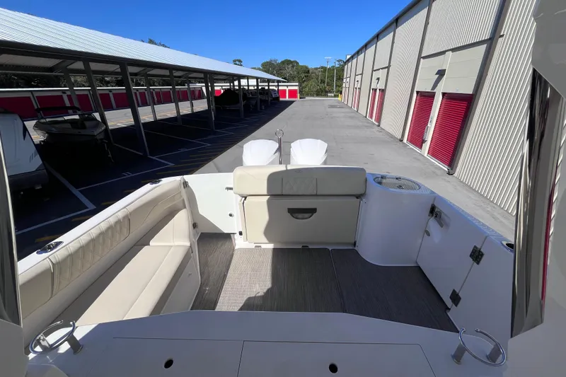  Yacht Photos Pics 2019 Regal 33 SAV boat interior with seating, docked in storage facility.