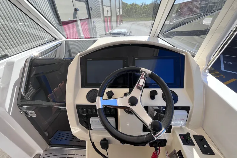  Yacht Photos Pics 2019 Regal 33 SAV boat helm with steering wheel and dual displays.