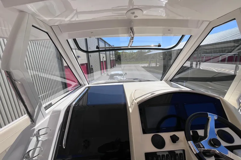  Yacht Photos Pics 2019 Regal 33 SAV boat cockpit with modern controls and panoramic view.