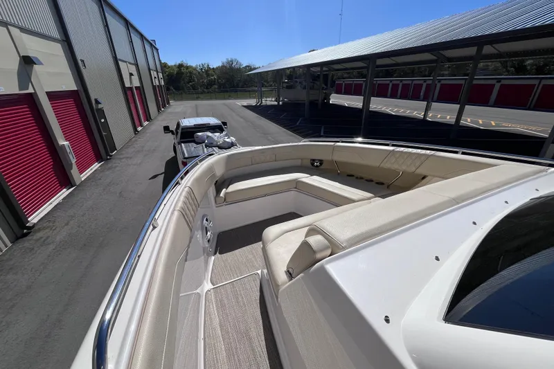  Yacht Photos Pics 2019 Regal 33 SAV boat with spacious seating, parked near storage units.