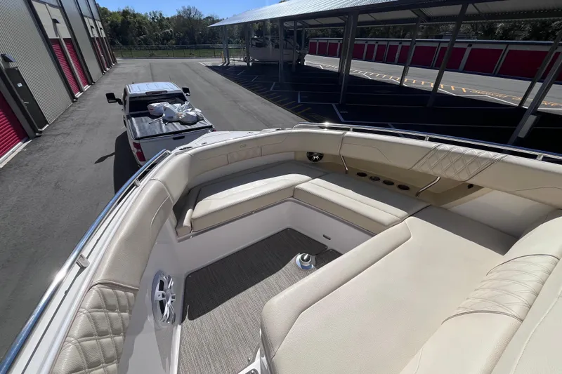  Yacht Photos Pics 2019 Regal 33 SAV boat with beige seating, parked near a pickup truck.