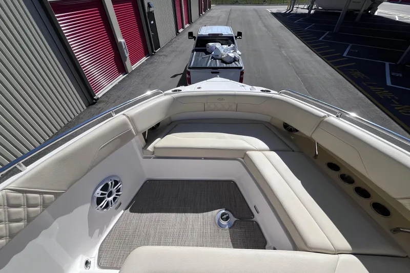  Yacht Photos Pics 2019 Regal 33 SAV boat interior with beige seating, parked near storage units.