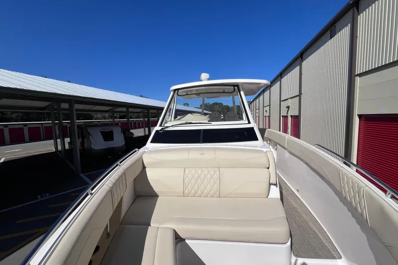  Yacht Photos Pics 2019 Regal 33 SAV boat with beige seating, parked in storage facility.
