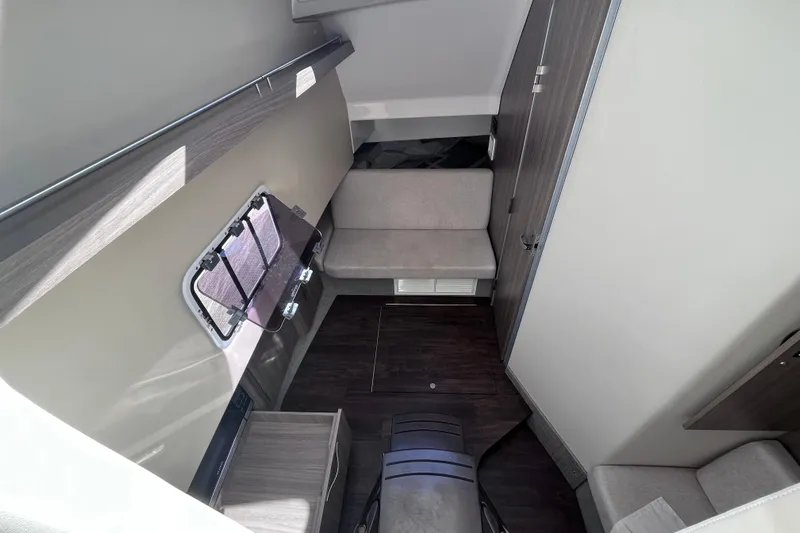  Yacht Photos Pics Interior cabin of 2019 Regal 33 SAV boat with seating and window.