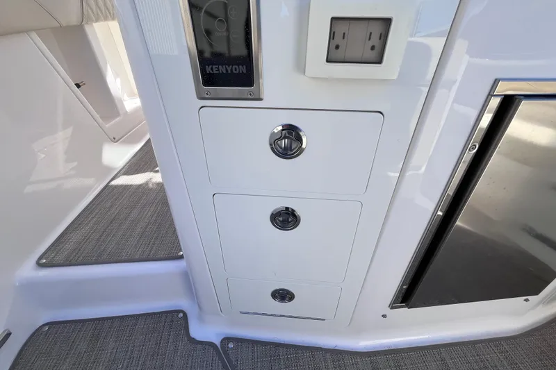  Yacht Photos Pics 2019 Regal 33 SAV interior with control panel and power outlet.