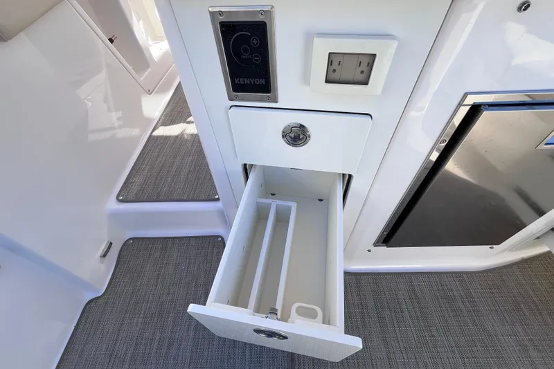  Yacht Photos Pics 2019 Regal 33 SAV boat interior with open drawer and electrical outlet.