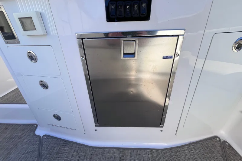  Yacht Photos Pics 2019 Regal 33 SAV boat interior with stainless steel storage compartment and control panel.