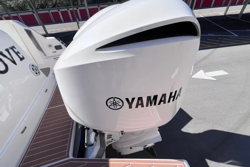  Yacht Photos Pics 2019 Regal 33 SAV boat with Yamaha outboard motor in a parking area.