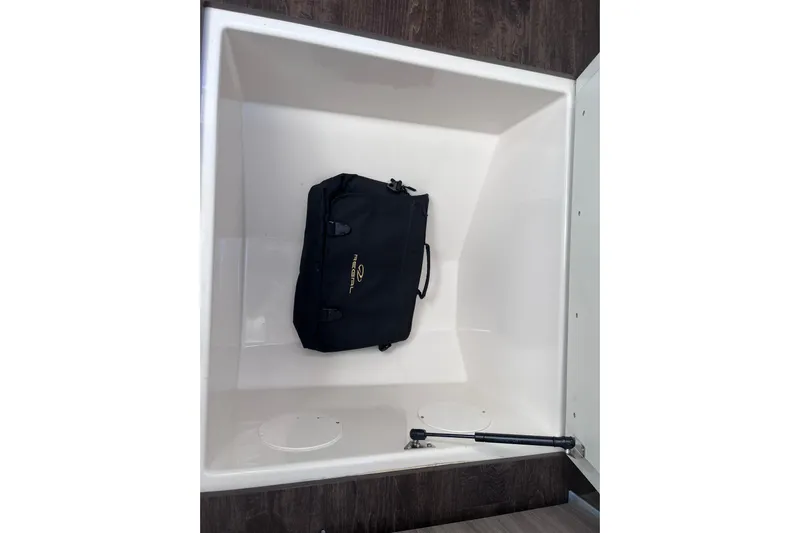  Yacht Photos Pics Storage compartment of 2019 Regal 33 SAV boat with a black bag inside.