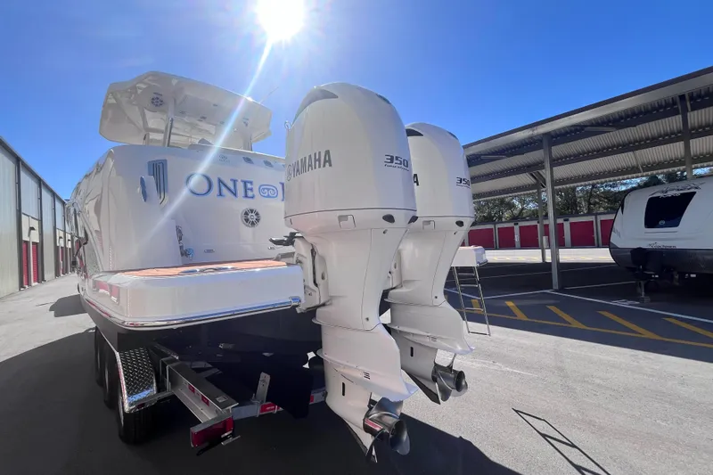  Yacht Photos Pics 2019 Regal 33 SAV boat with twin Yamaha 350 engines in a sunny storage area.