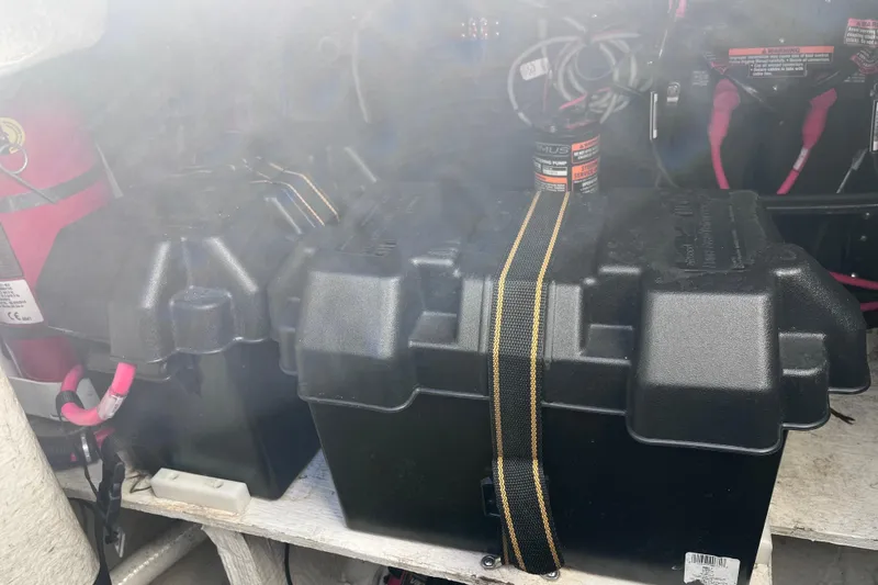  Yacht Photos Pics Battery compartment of a 2019 Regal 33 SAV boat with secured black battery boxes.