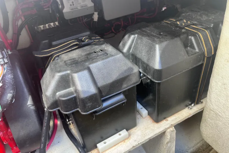  Yacht Photos Pics Battery compartment of a 2019 Regal 33 SAV boat, featuring secured black battery boxes.