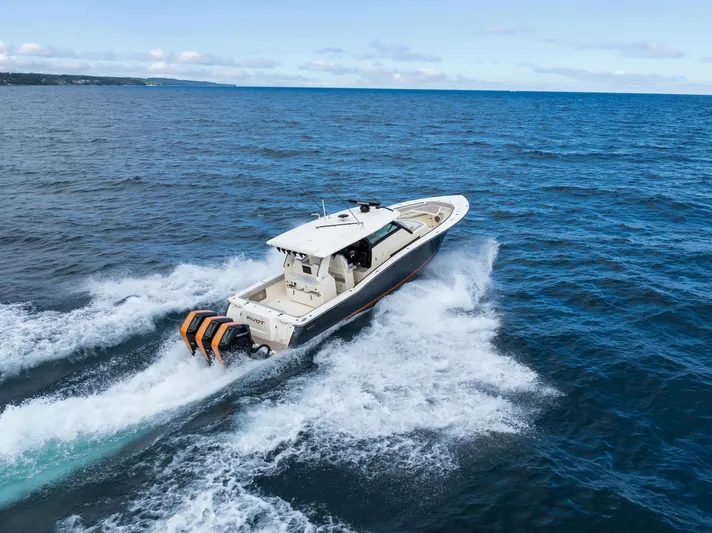  Yacht Photos Pics 2023 Scout 425 LXF boat cruising on open ocean waters.