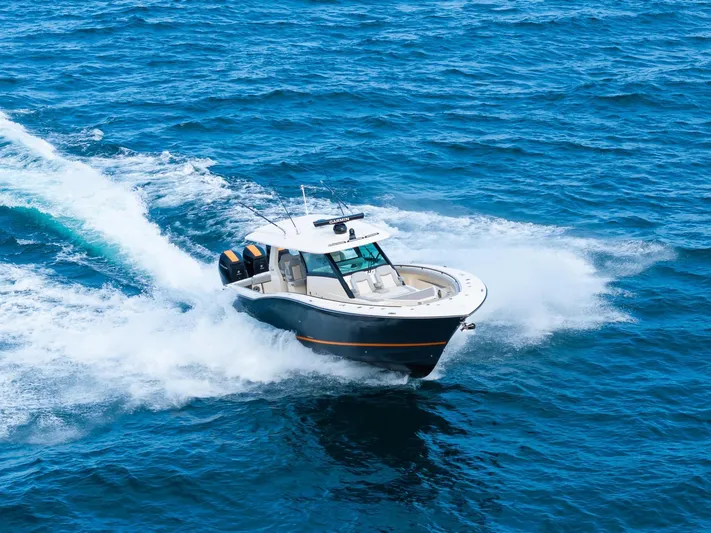  Yacht Photos Pics 2023 Scout 425 LXF boat cruising on open blue ocean waters.