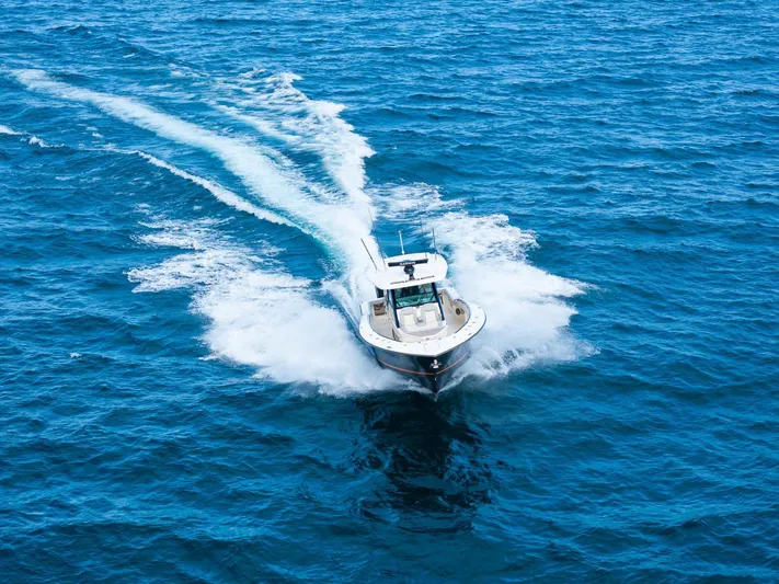  Yacht Photos Pics 2023 Scout 425 LXF boat cruising on open blue ocean waters.