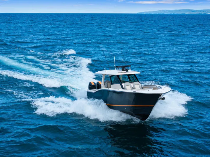  Yacht Photos Pics 2023 Scout 425 LXF boat cruising on open ocean waters.