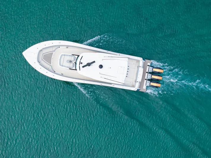  Yacht Photos Pics Aerial view of 2023 Scout 425 LXF boat cruising on turquoise water.