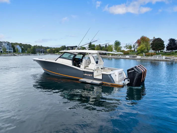  Yacht Photos Pics 2023 Scout 425 LXF boat on calm water, showcasing sleek design and powerful engines.