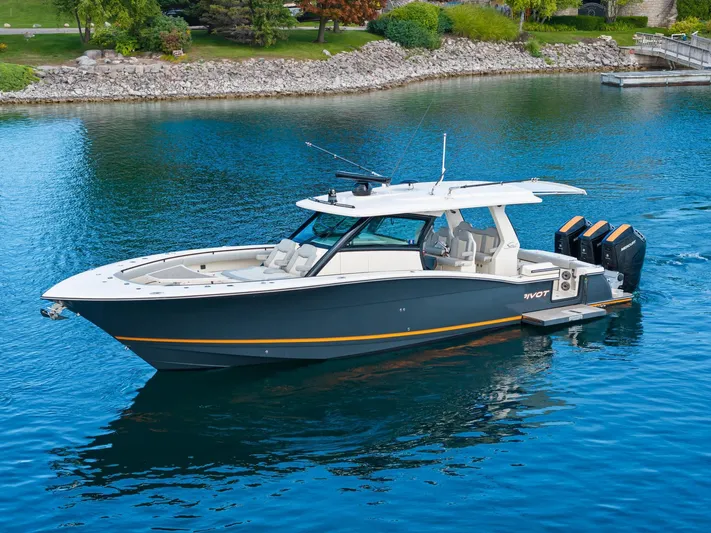  Yacht Photos Pics 2023 Scout 425 LXF boat on calm water, featuring sleek design and powerful engines.