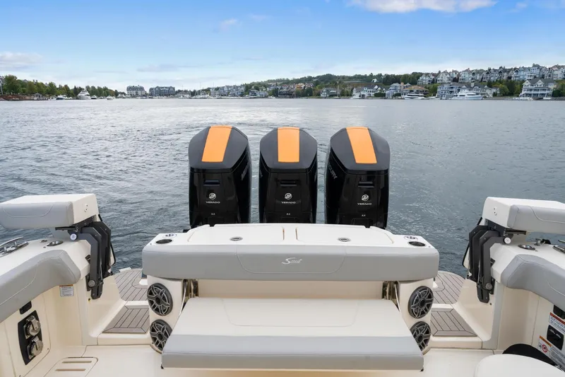  Yacht Photos Pics 2023 Scout 425 LXF boat with triple engines on a calm lake.