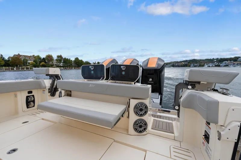  Yacht Photos Pics 2023 Scout 425 LXF boat with seating and engines on a calm waterway.