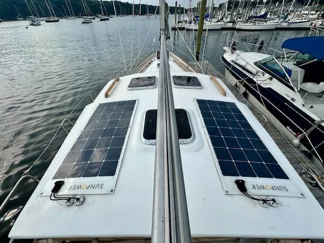  Yacht Photos Pics Sailboat with solar panels on deck, Vilm 116 model, 2002, docked in a marina.