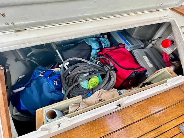  Yacht Photos Pics Storage compartment of 2002 Vilm 116 boat with bags and coiled ropes.