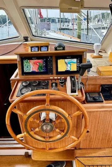  Yacht Photos Pics Wooden helm of 2002 Vilm 116 yacht with navigation screens.