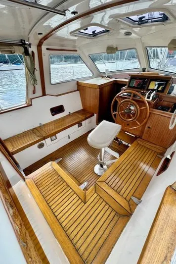  Yacht Photos Pics Interior of 2002 Vilm 116 boat with wooden helm and seating.