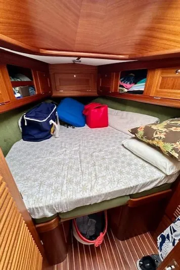  Yacht Photos Pics Cozy cabin interior of 2002 Vilm 116 yacht with wooden finish and storage.