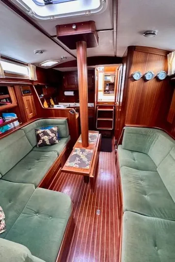 Yacht Photos Pics Interior of 2002 Vilm 116 yacht with green seating and wooden finishes.