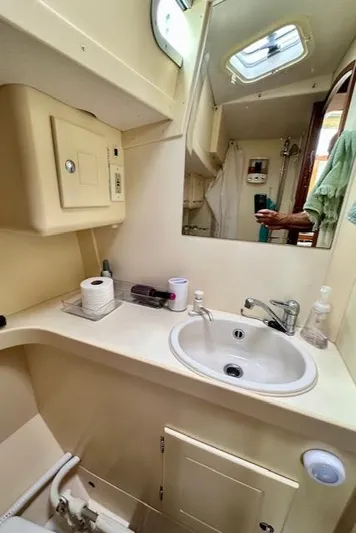  Yacht Photos Pics Compact bathroom in 2002 Vilm 116 yacht with sink, mirror, and storage.