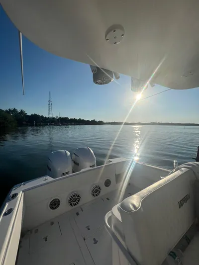 30 Intrepid Center Console Yacht Photos Pics 2004 Intrepid 300 Center Console boat on calm water at sunset.