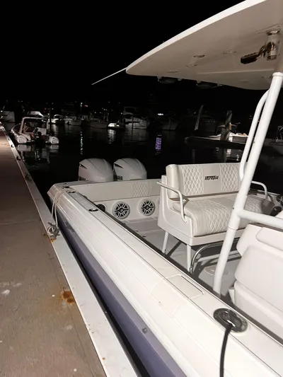 30 Intrepid Center Console Yacht Photos Pics 2004 Intrepid 300 Center Console boat docked at night with visible seating and twin engines.