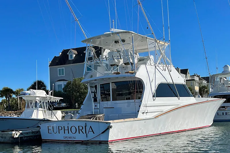 Euphoria Yacht Photos Pics Custom Carolina Precision Sportfish 2000 docked, featuring sleek design and fishing equipment.